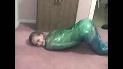 Fetish chick loves being wrapped in green plastic with her shaved pussy Thumb